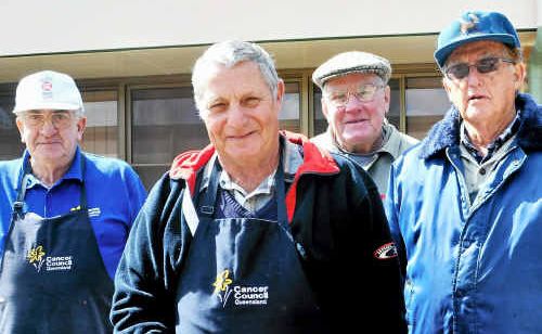 Terry Brown, Con Seibel, Jack Jones and Ken Hartnett prepare sausages for the hungry guests at the Music in the Park concert. 